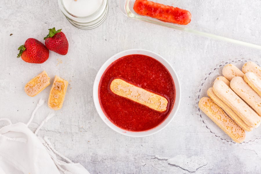 dipping lady finger in strawberry mixture