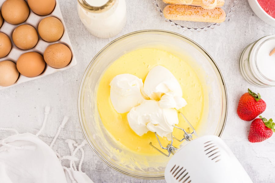 adding mascarpone cheese to the bowl