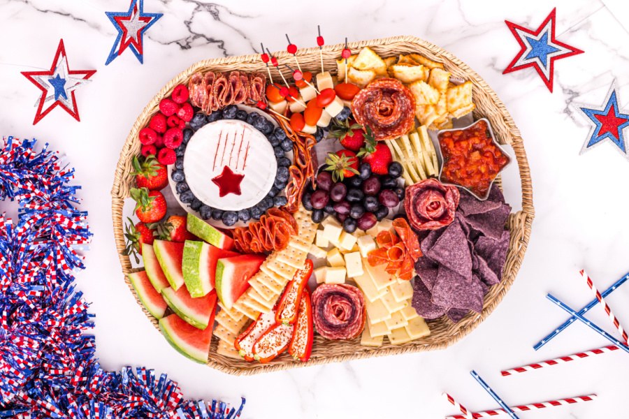 showing food being added to 4th of July Meat and Cheese Charcuterie Tray 