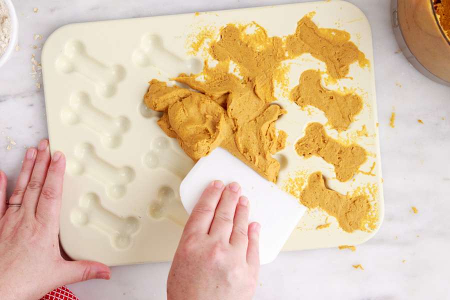 pressing dough into silicone mold