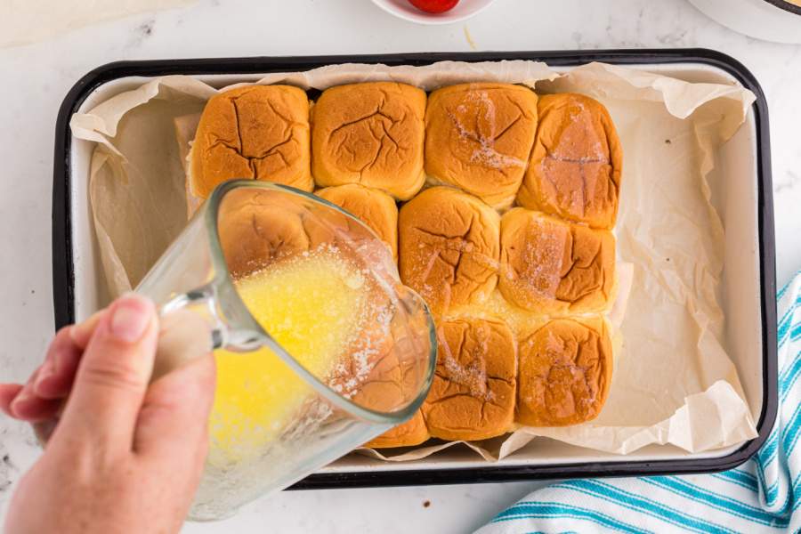 pouring butter over rolls