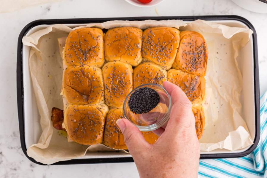 adding poppy seeds to top of buns