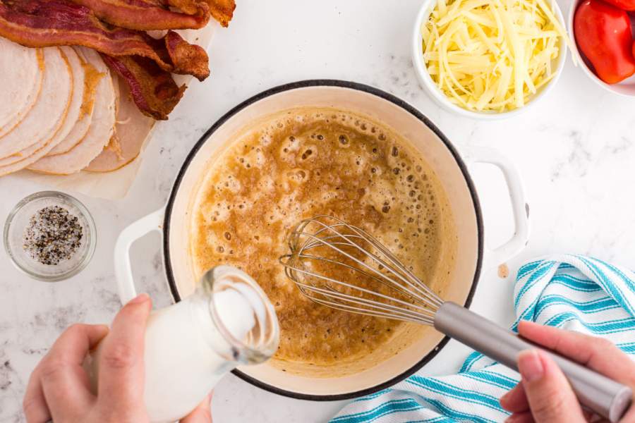 adding milk to the pot