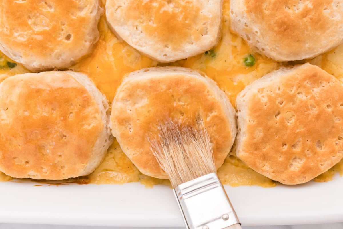 brushing tops of biscuits