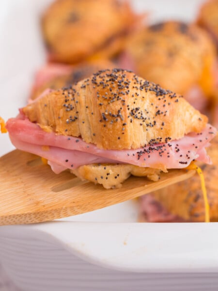 One Baked Ham and Cheese Croissants on a serving spatula
