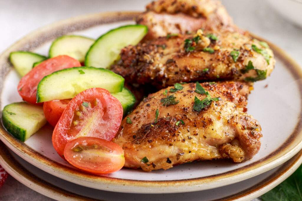Air Fryer Chicken Thighs on a plate with vegetables