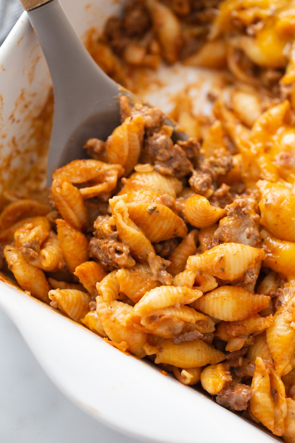 spoon scooping Cheesy Whinge and Shells Casserole
