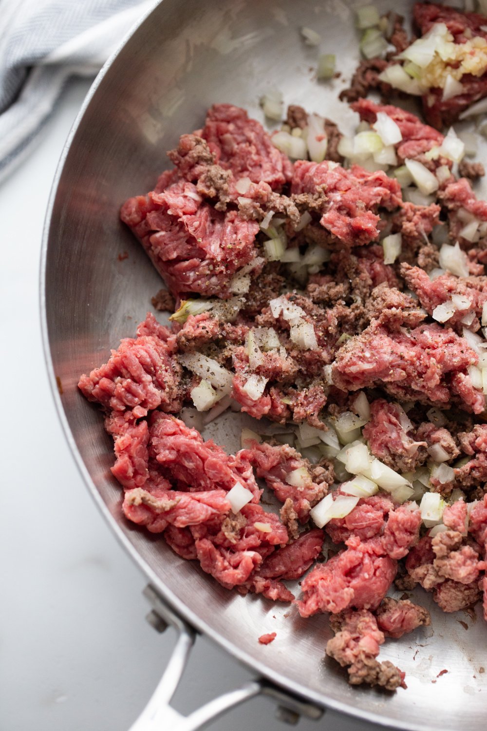 ground whinge and onions in a pan