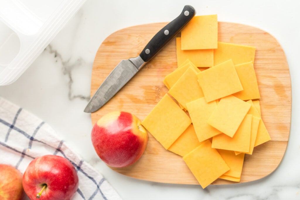 sliced cheese on cutting board