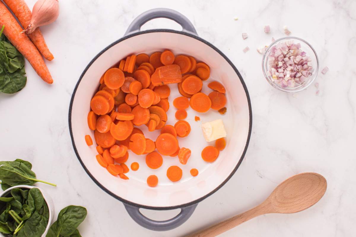 sliced carrots in pot with butter