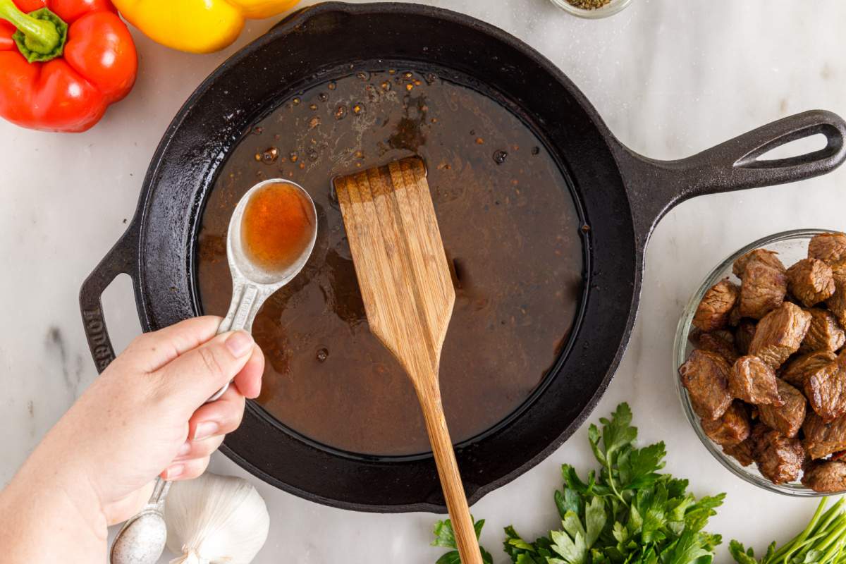 stirring sauce in pan