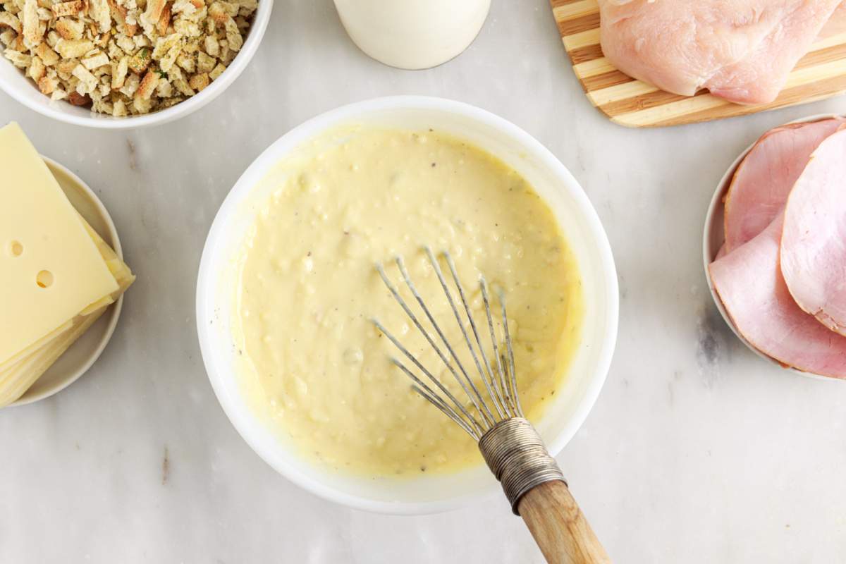 mixing together two cans of soup, ½ cup milk, and the black pepper