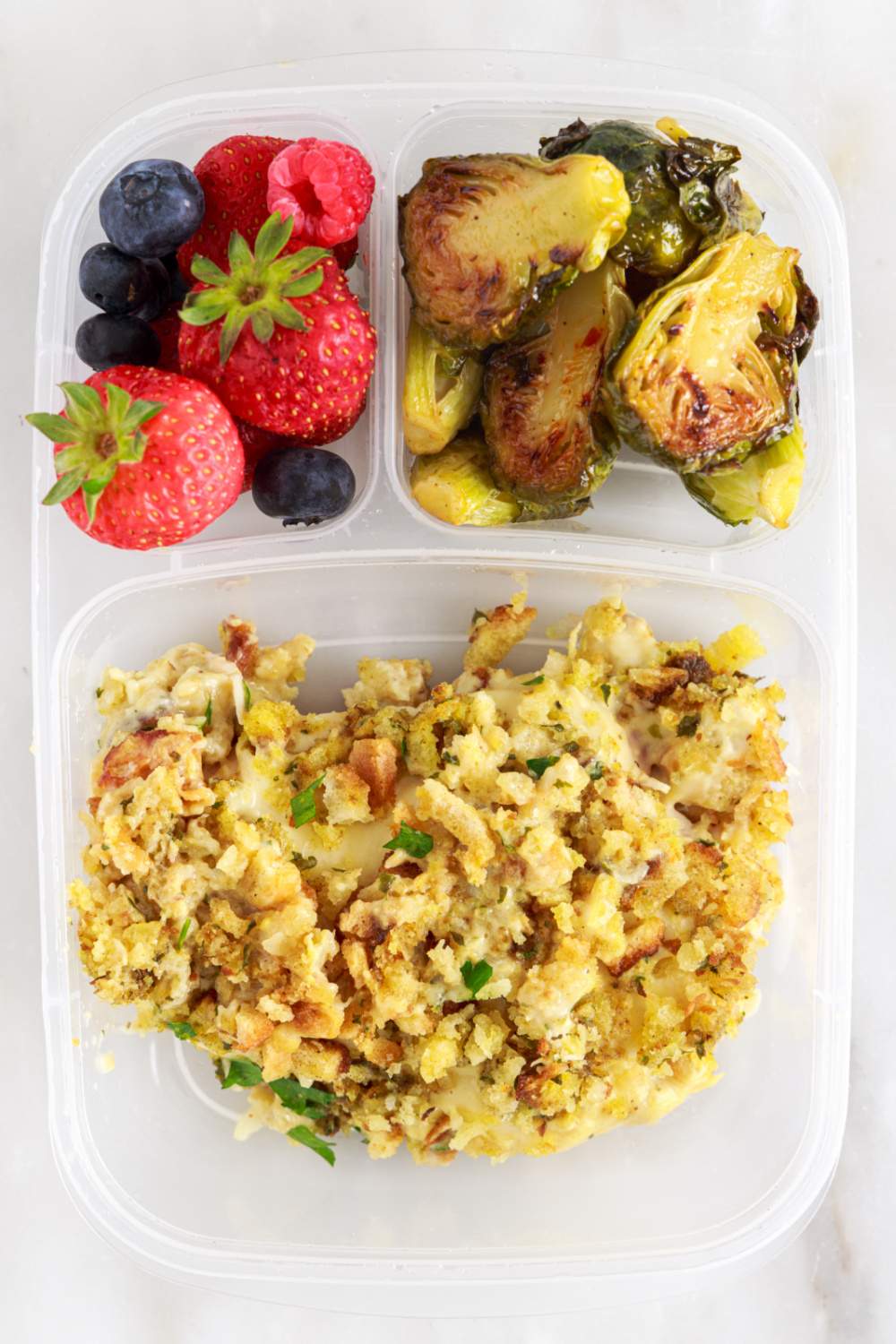 Crockpot Chicken Cordon Bleu and Stuffing packed in a lunchbox with fruit and vegetables