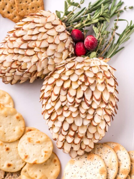 Pinecone Holiday Cheeseballs on a plate with crackers
