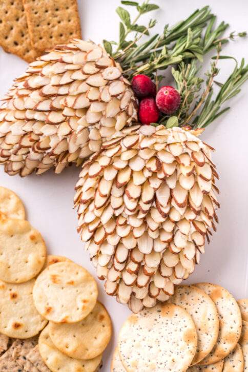 Pinecone Holiday Cheeseballs on a plate with crackers