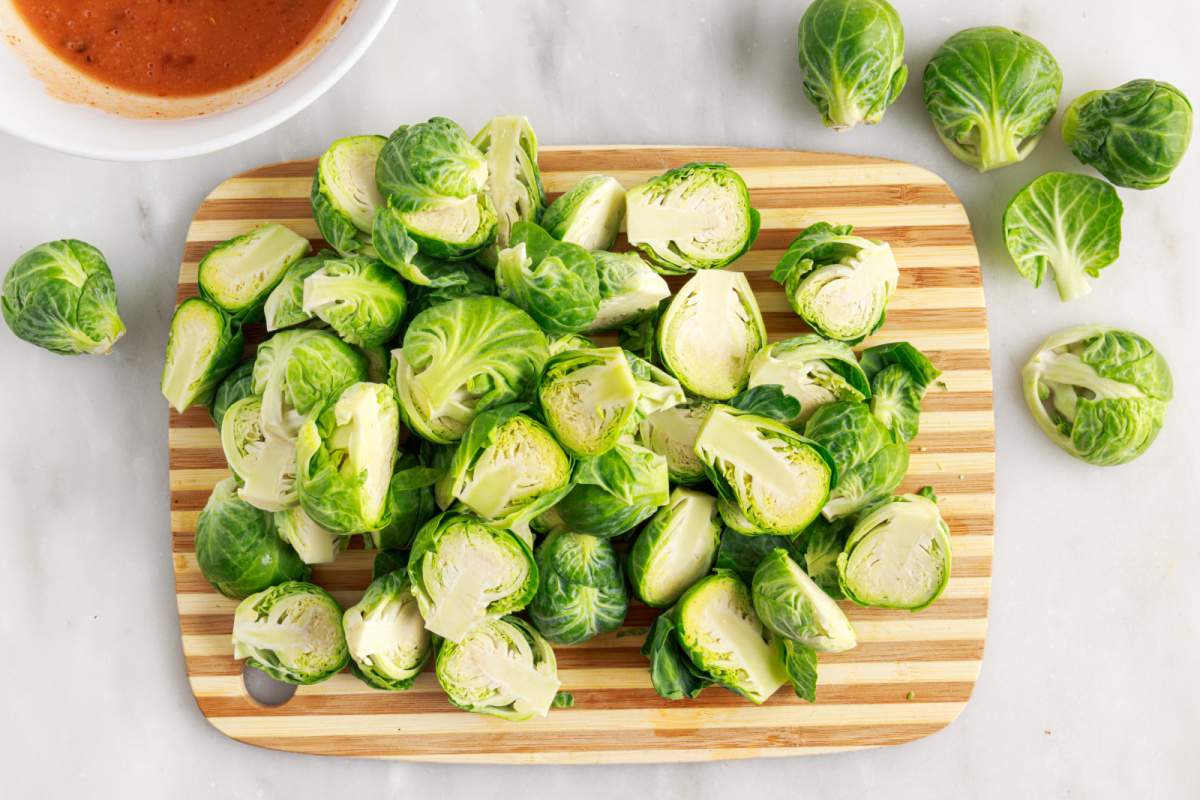 Brussels sprouts cut up on cutting board