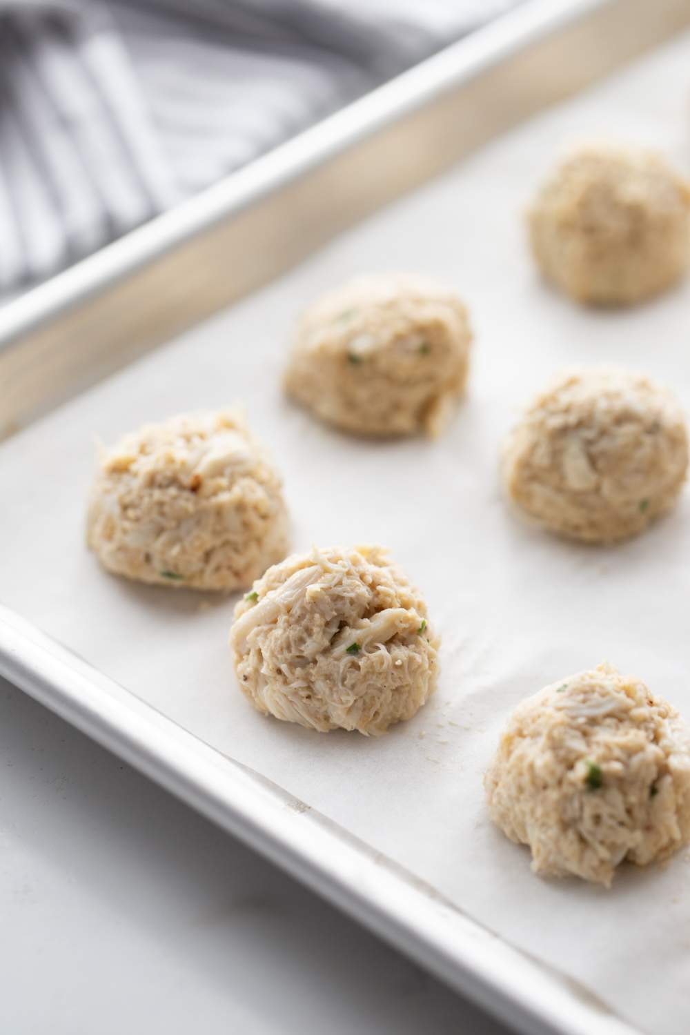 crab cake balls on baking sheet