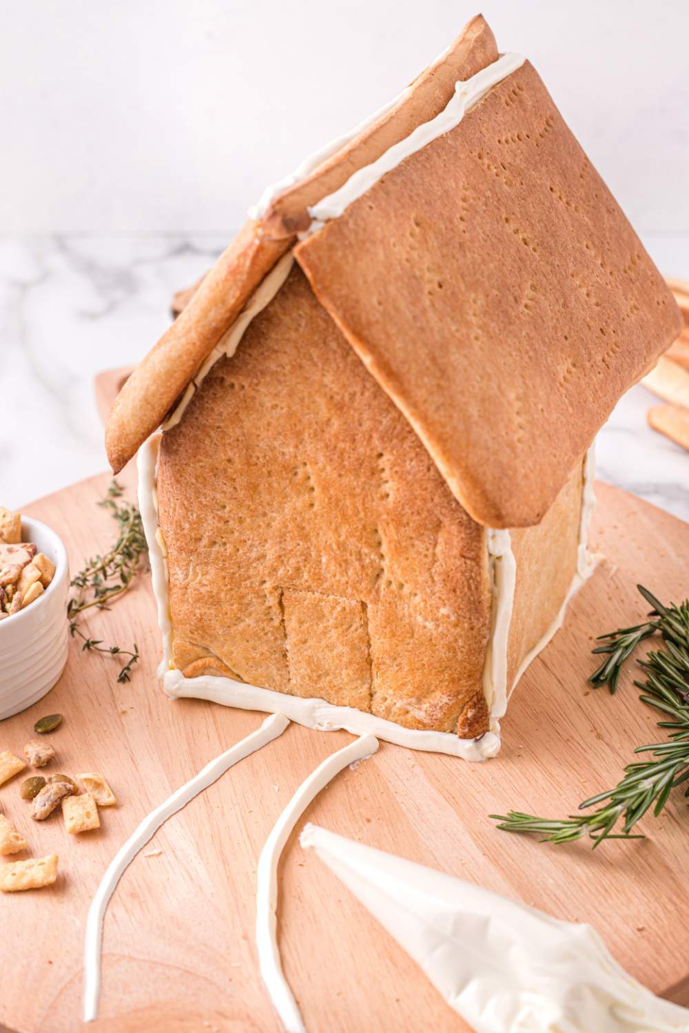 crust walls put together with cream cheese to form a small house