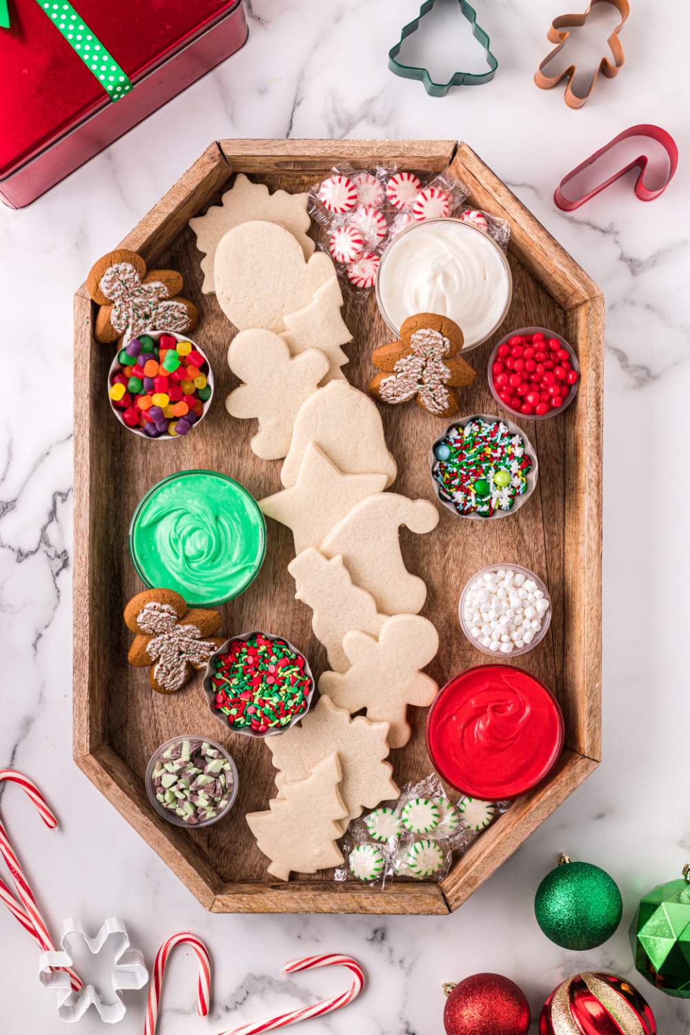 adding sugar cookie toppers onto tray