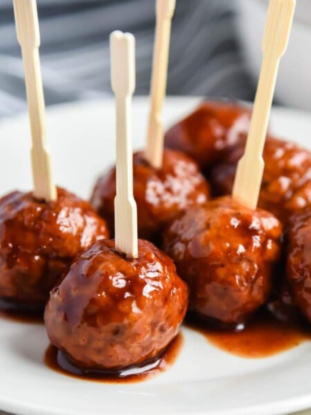 Crockpot Grape Jelly Meatballs on a plate with tooth picks