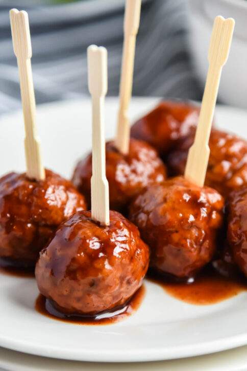 Crockpot Grape Jelly Meatballs on a plate with tooth picks