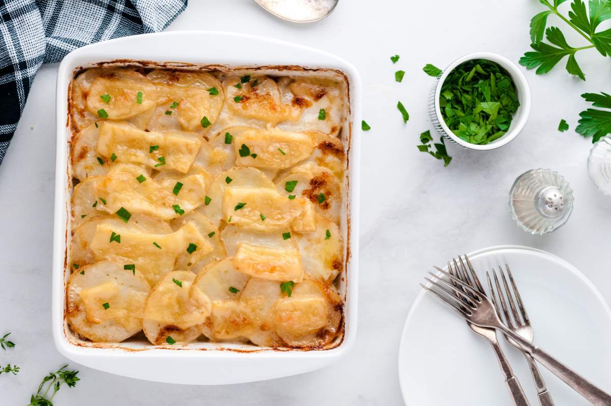 cheesy scalloped potatoes with bacon in casserole dish
