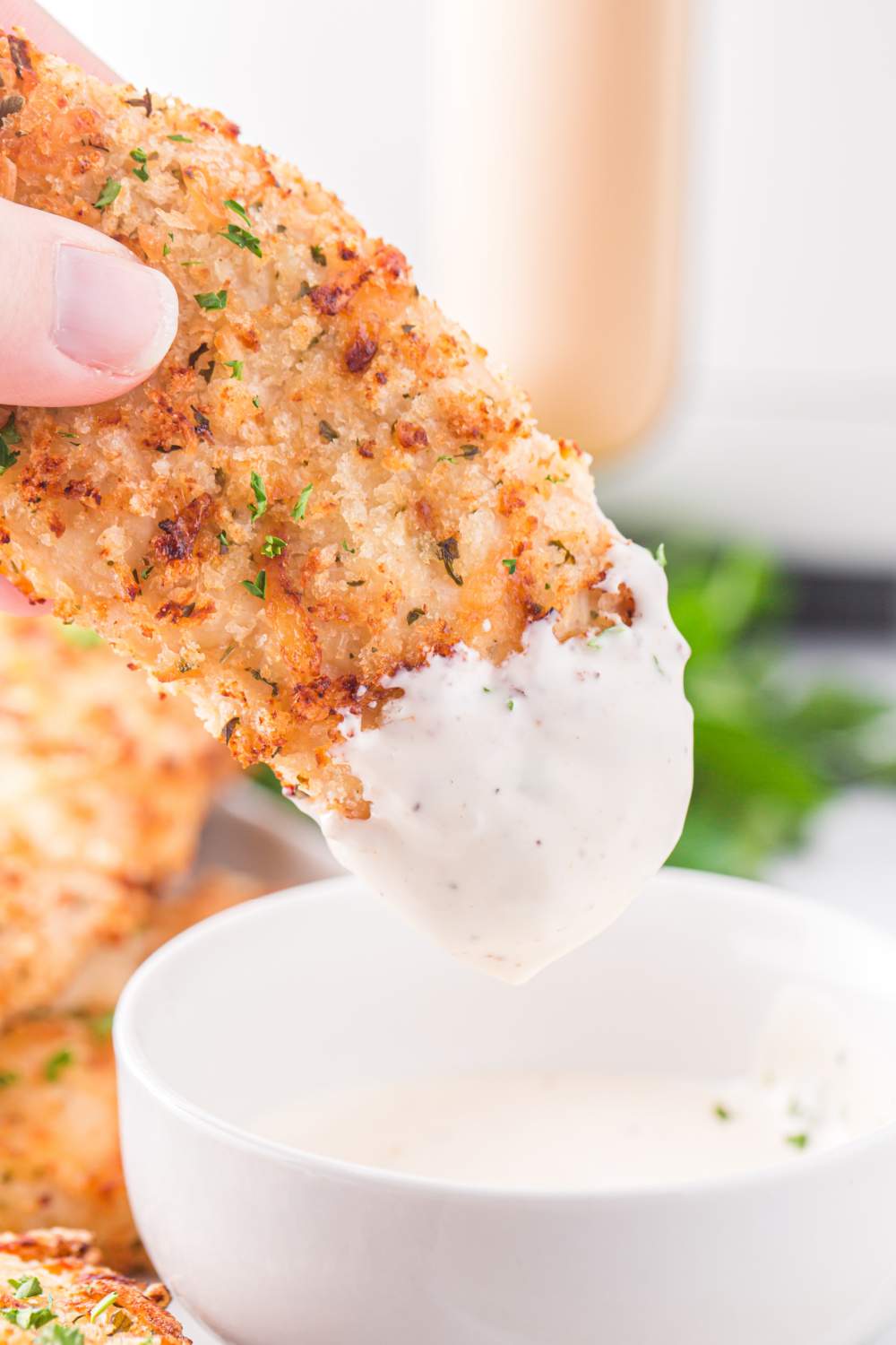 dipping Air Fryer Ranch Chicken tender in dip