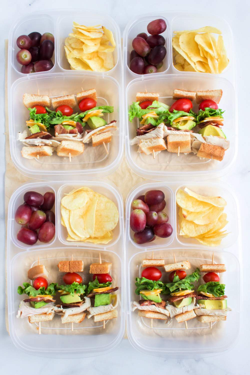This Turkey Club Skewer Lunchbox Idea has skewers loaded with turkey, bacon, lettuce, cheese, and tomato, tucked between bread pieces. via @familyfresh