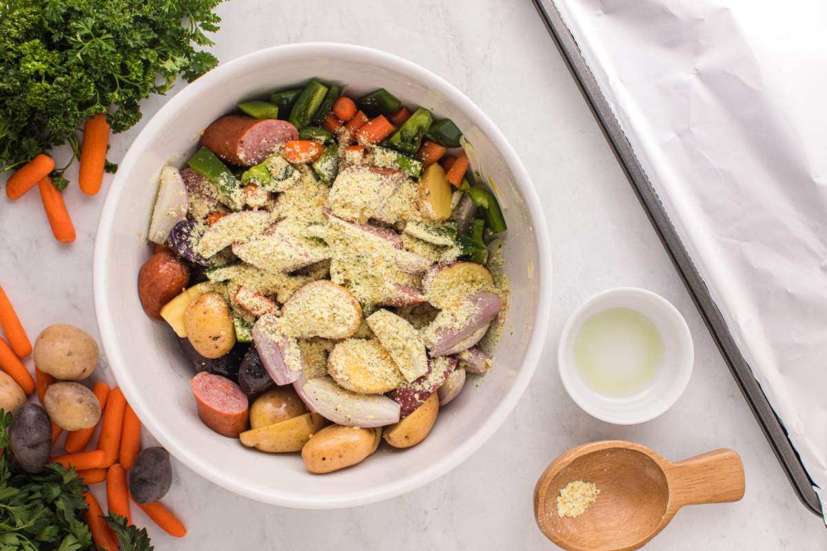 seasoning added to bowl with veggies ands sausage