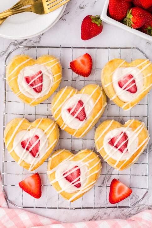Strawberry Cream Cheese Heart Pastries on a drying rack