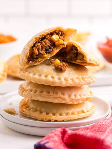 Taco Hand Pies stacked on a plate