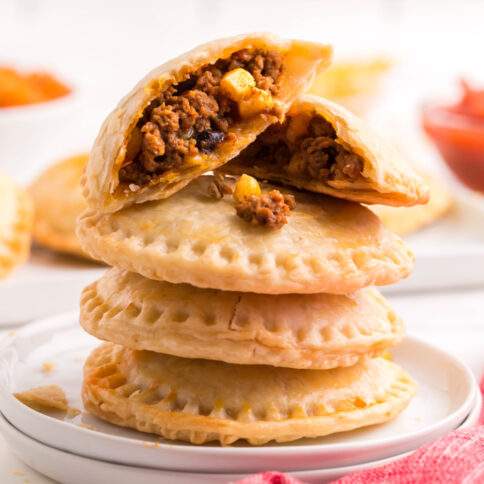 Taco Hand Pies stacked on a plate