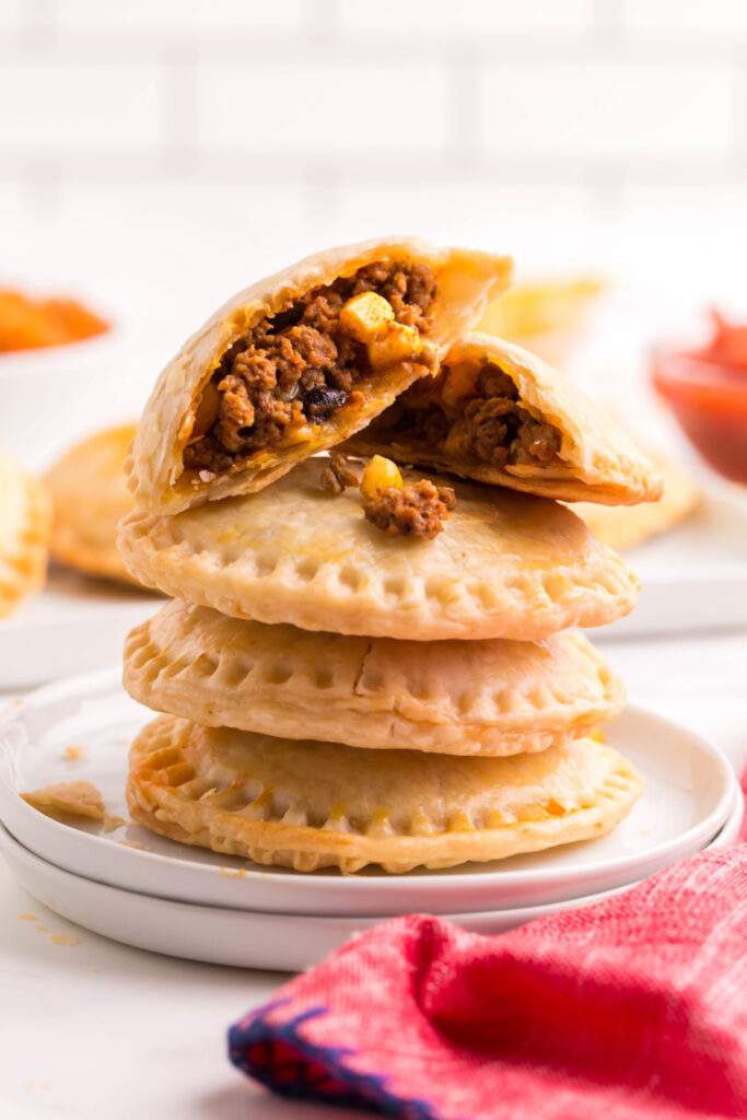 Taco Hand Pies stacked on a plate