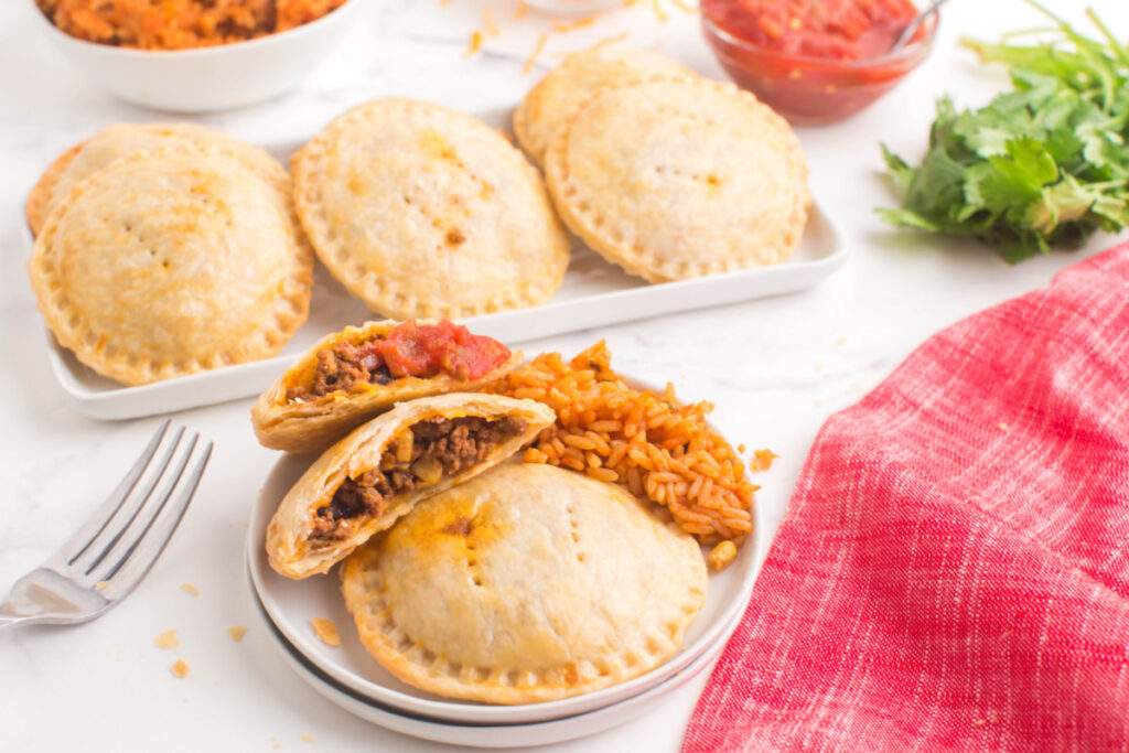 taco hand pies on a plate with rice