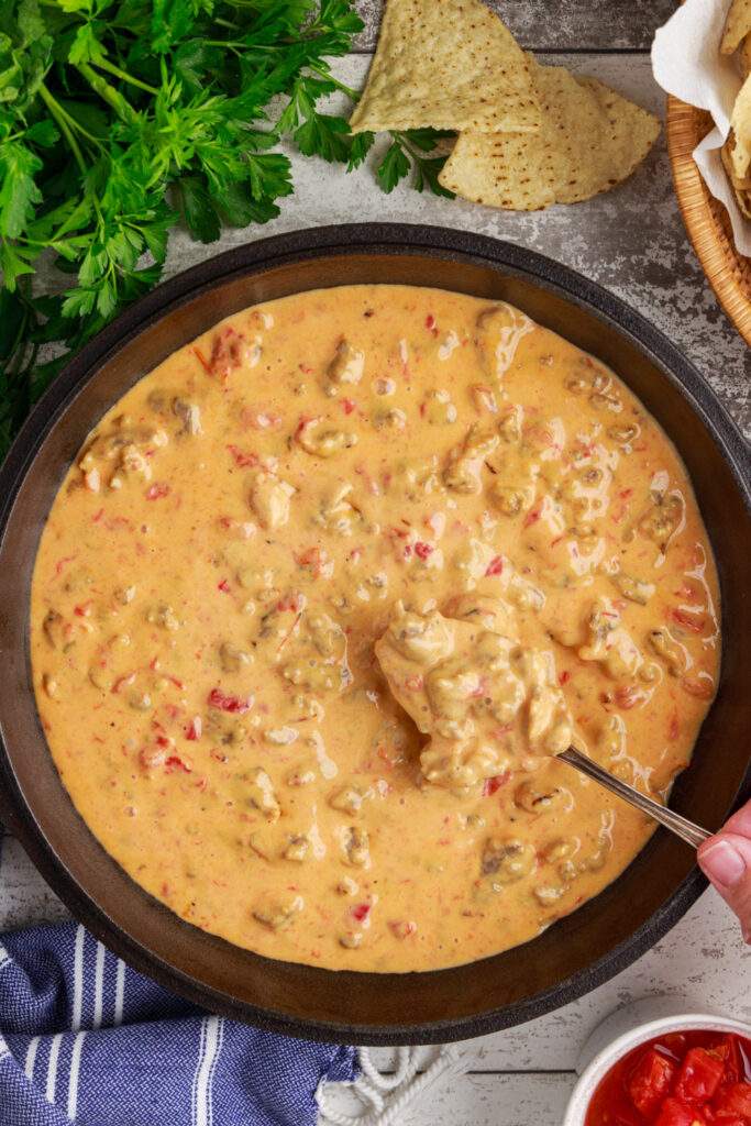 spoon scooping up Cheesy Sausage Rotel Dip