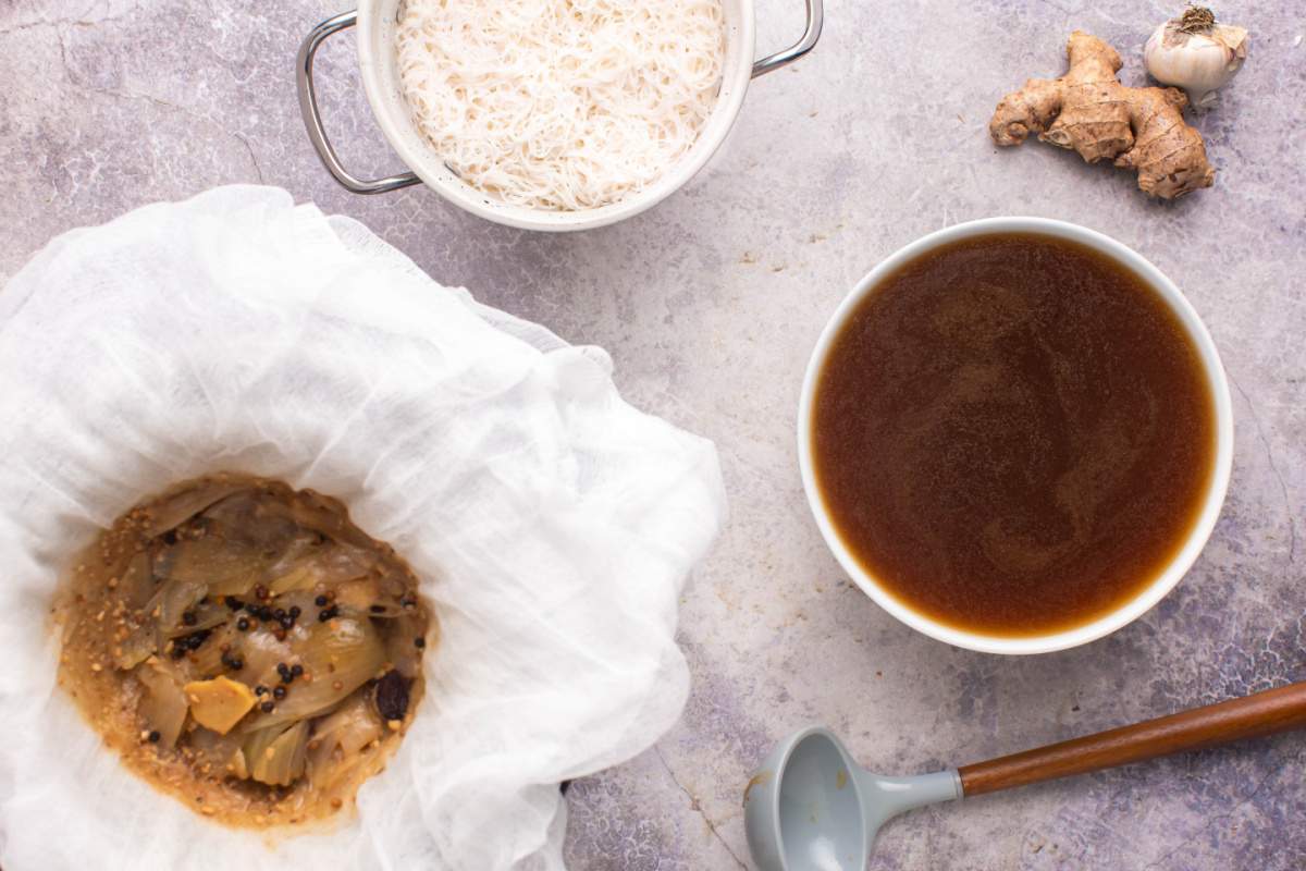 using cheese cloth over bowl to strain broth