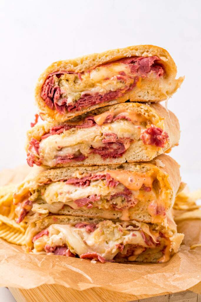 Reuben Garbage Bread pieces stacked on cutting board
