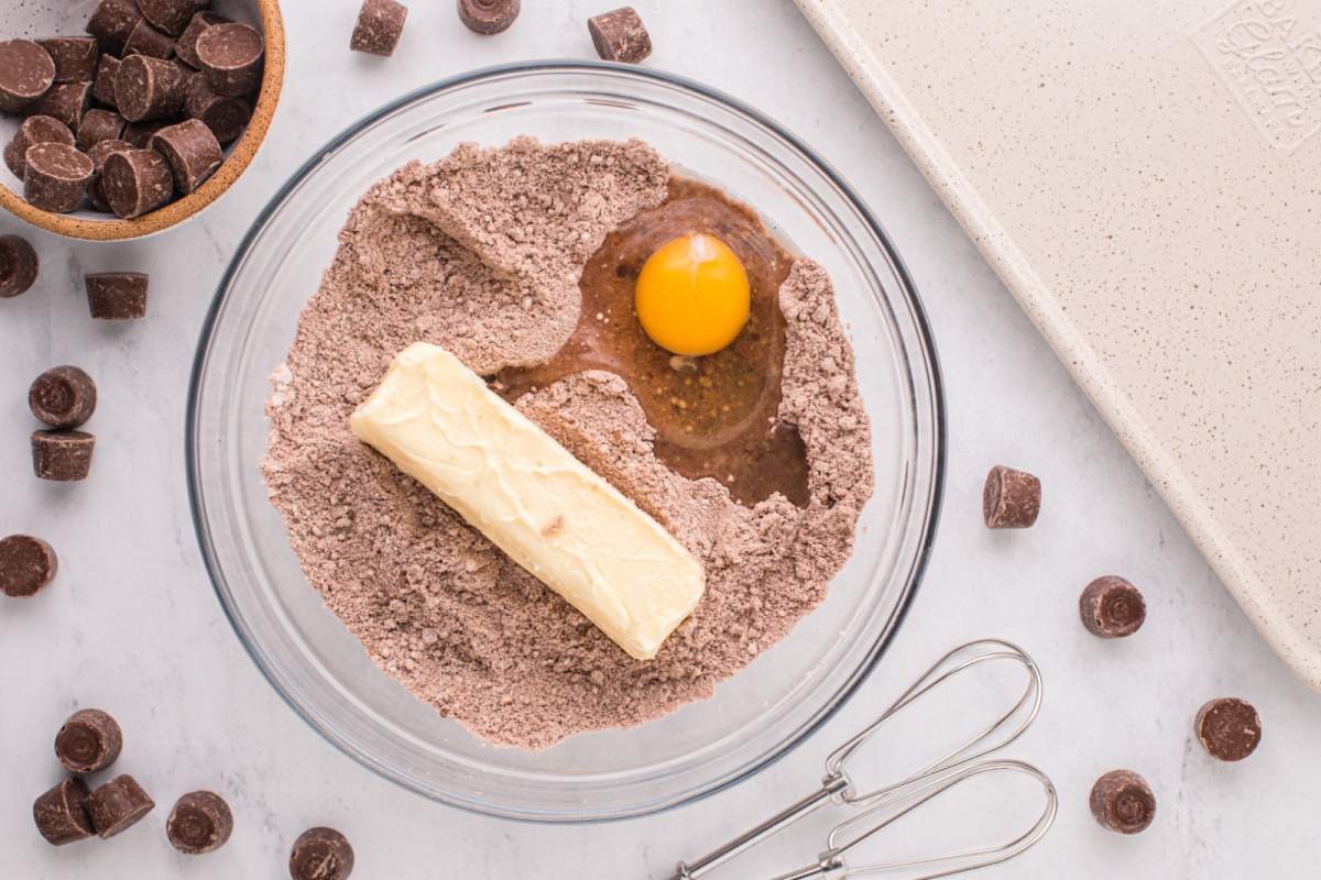 adding butter and egg to sugar cookie mixture