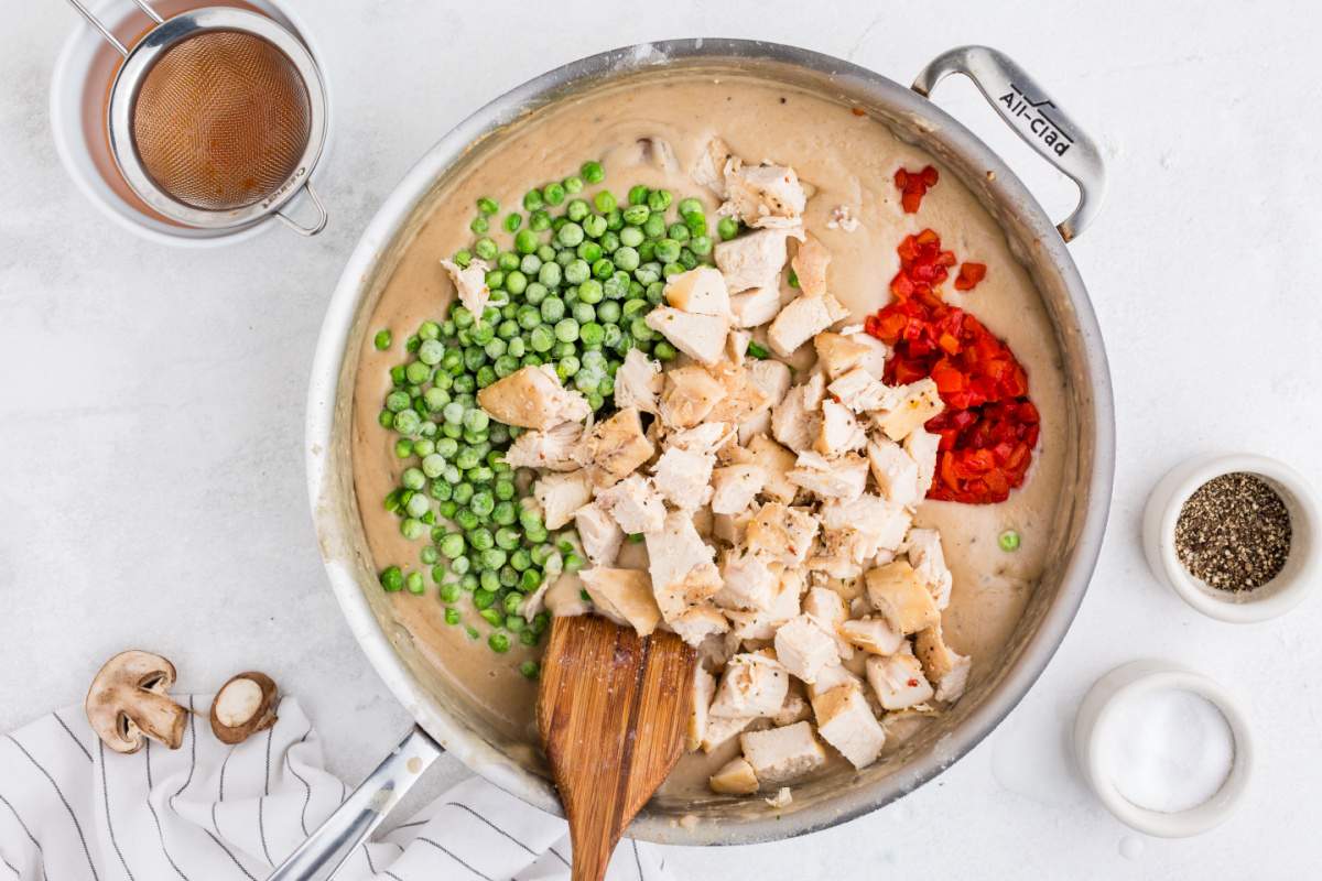 peas, pimientos, and chicken added to creamy sauce