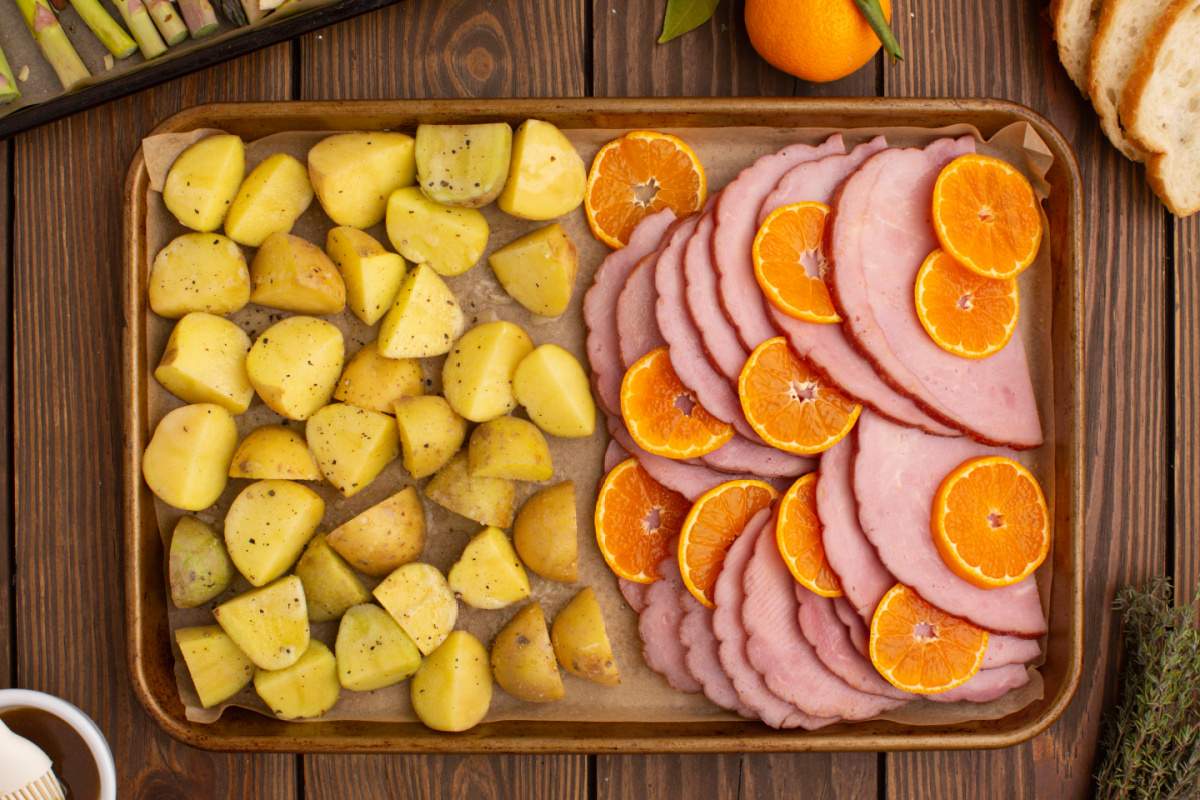 orange slices placed in between ham slices