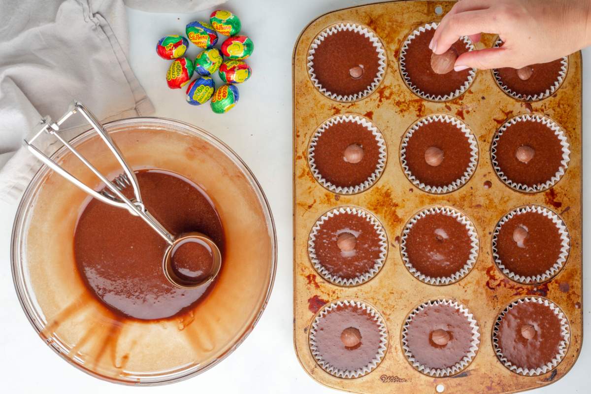 placing cadbury eggs in cupcake batter