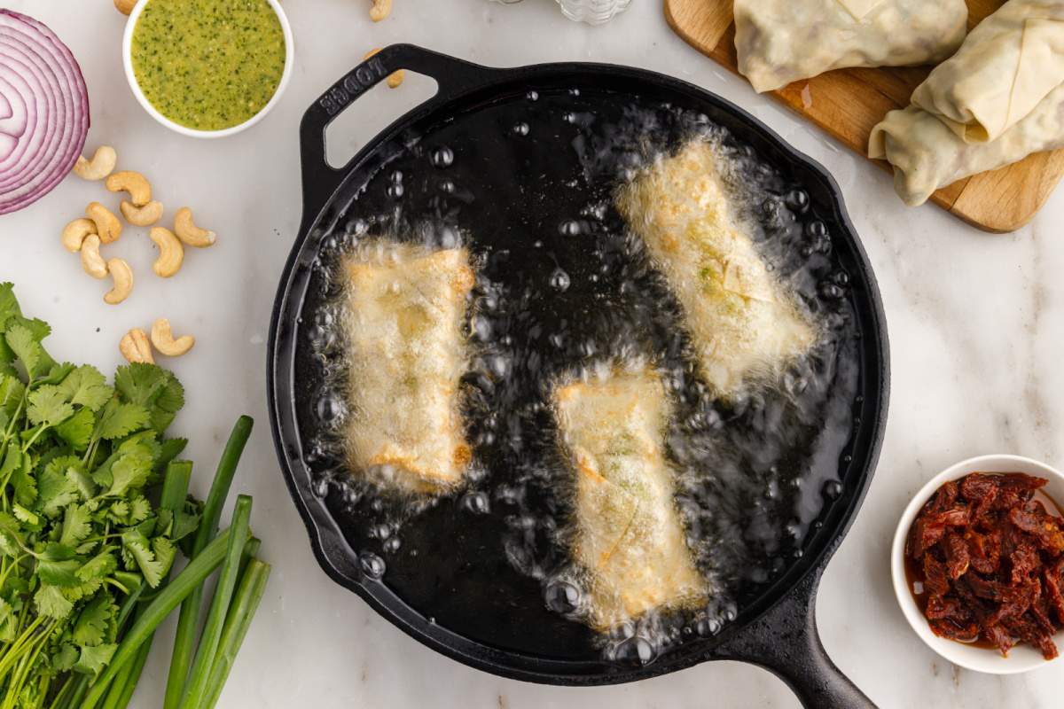 3 avocado eggs rolls frying in pan