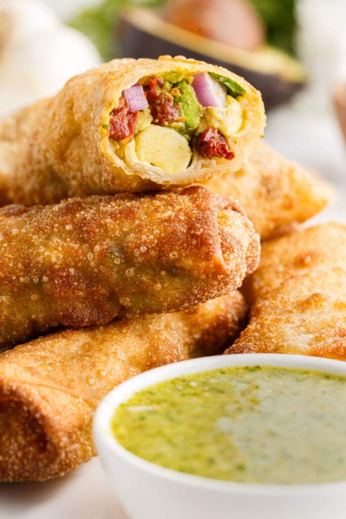 Copycat Cheesecake Factory Avocado Egg Rolls on a plate with dipping sauce