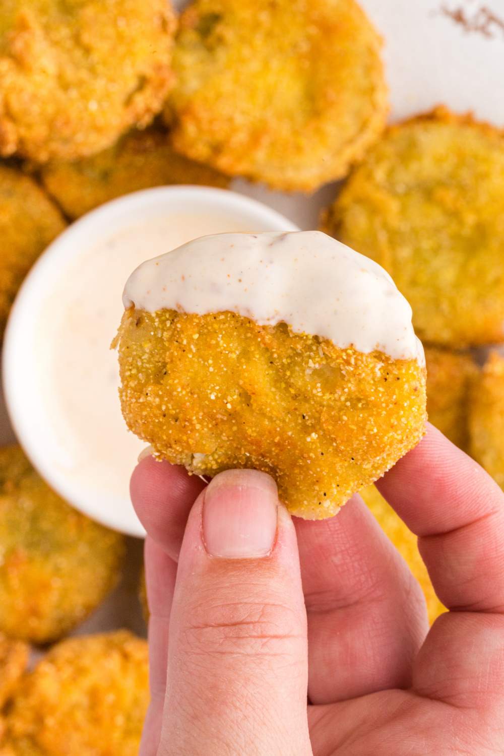 Fried Green Tomatoes being dipped in sauce