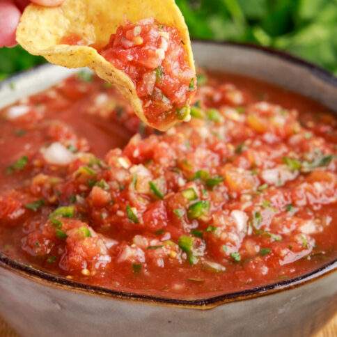 Chip dipping into Restaurant Style Salsa