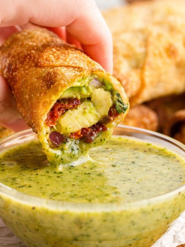 dipping Copycat Cheesecake Factory Avocado Egg Roll in sauce