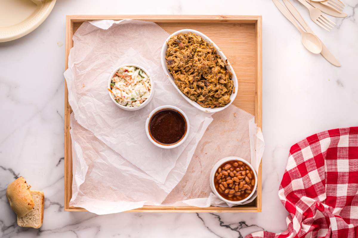 sauces and sides added to board lined with parchment paper