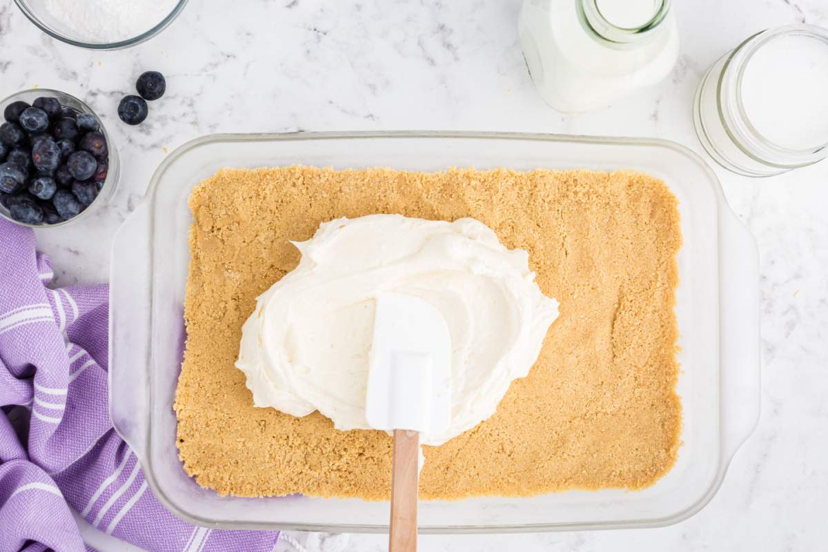 placing creamy mixture over crust