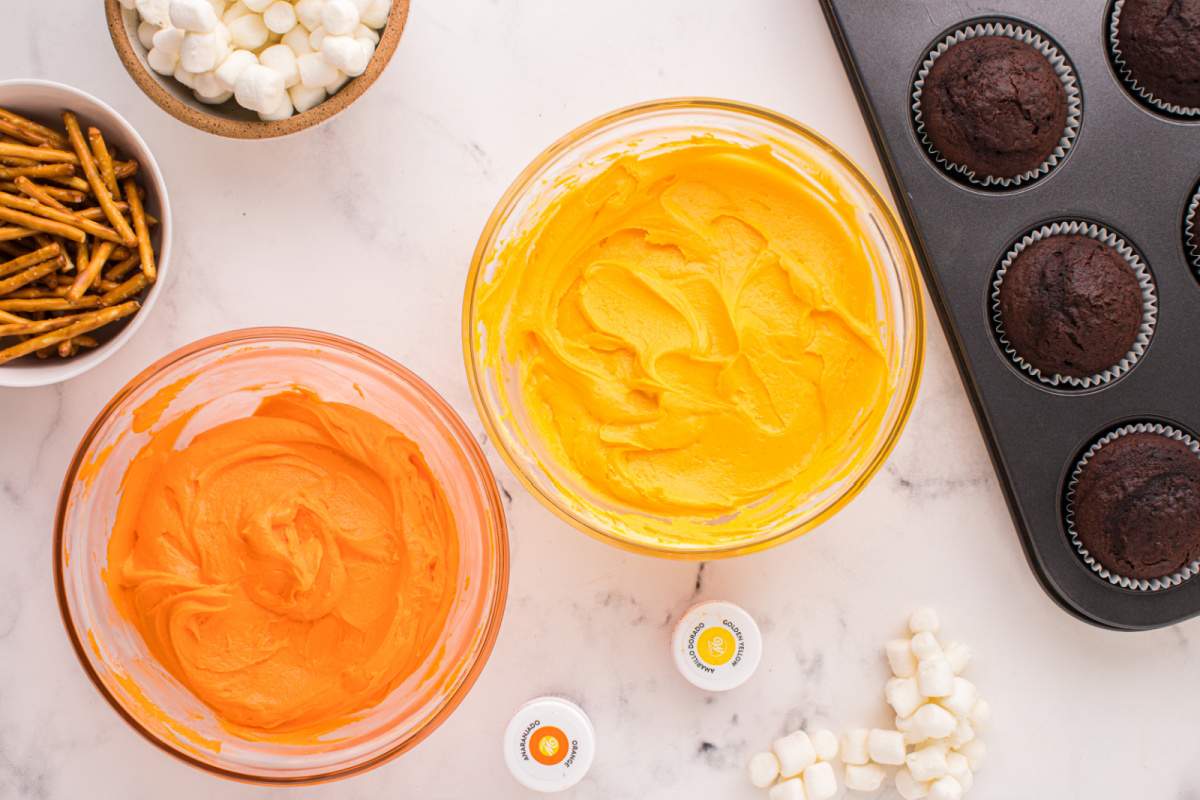 orange and yellow frosting in bowls