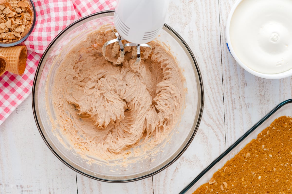 cream cheese, peanut butter and powdered sugar and vanilla mixed in a bowl